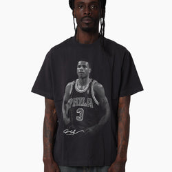 Person wearing a black t-shirt with a graphic of a basketball player and text.