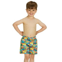 Child wearing colorful swim shorts on a white background
