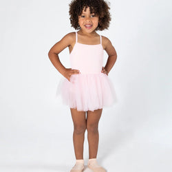 Young girl wearing a pink tutu dress on a white background