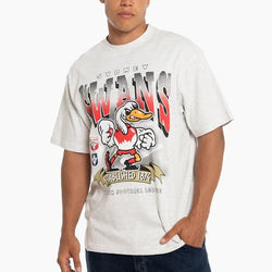 Man wearing a white t-shirt with a cartoon character design on a white background