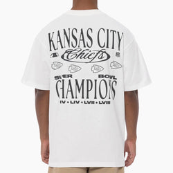 Person wearing a white 'Kansas City Chiefs' t-shirt with text on the back.