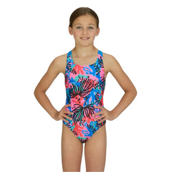 Girl wearing a colorful swimsuit with a tropical leaf pattern on a white background