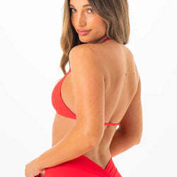 Woman wearing a red bikini with a white background